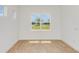 Bedroom featuring a large window with views of the well-manicured lawn at 8980 Sw 52Nd Place Rd, Ocala, FL 34481