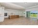Open floor plan featuring a modern kitchen and a bright living space with sliding glass doors at 8980 Sw 52Nd Place Rd, Ocala, FL 34481