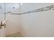 Tiled shower showcasing a rainfall showerhead, built-in niche, and accent tile at 8980 Sw 52Nd Place Rd, Ocala, FL 34481