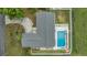 Aerial view of the home showing the backyard swimming pool and fence and the driveway and landscaping in front at 4523 Oakglen Rd, Lakeland, FL 33813
