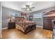 Spacious bedroom with hardwood floors, a ceiling fan, and ample natural light at 4523 Oakglen Rd, Lakeland, FL 33813