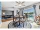 Cozy dining area features a round table, stylish chairs, and a sliding glass door to the outdoor pool at 4523 Oakglen Rd, Lakeland, FL 33813