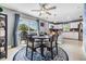 Cozy dining area features a round table, stylish chairs, and a sliding glass door to the outdoor pool at 4523 Oakglen Rd, Lakeland, FL 33813