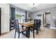 Dining room features a modern table with seating for six and sliding glass doors leading to the backyard at 4523 Oakglen Rd, Lakeland, FL 33813