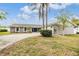 Charming single-story home featuring a circular driveway, attached garage, and well-maintained landscaping at 4523 Oakglen Rd, Lakeland, FL 33813