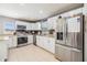 Bright kitchen features white cabinets, stainless steel appliances, granite countertops, and a stylish backsplash at 4523 Oakglen Rd, Lakeland, FL 33813