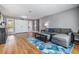 Bright living room with hardwood floors, modern sofa, and ample natural light from the nearby windows at 4523 Oakglen Rd, Lakeland, FL 33813