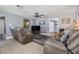 Cozy living room features tile flooring and a comfortable reclining sofa set at 4523 Oakglen Rd, Lakeland, FL 33813