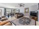 Open-concept living room with a comfortable sofa, dining area, and stylish rug at 4523 Oakglen Rd, Lakeland, FL 33813
