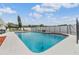 Sparkling private pool with adjacent patio seating and clear blue skies at 4523 Oakglen Rd, Lakeland, FL 33813