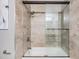 Shower has tile surround and glass door at 4523 Oakglen Rd, Lakeland, FL 33813