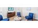 Modern reception area with blue chairs and a wood cabinet for a professional and welcoming first impression at 4764 Waltham Forest Dr, Davenport, FL 33837