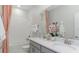 Bathroom with double sinks, a shower, and elegant decor at 4779 Waltham Forest Dr, Davenport, FL 33837