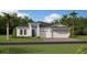 Inviting single-story home featuring a three-car garage and well-maintained landscaping at 4779 Waltham Forest Dr, Davenport, FL 33837