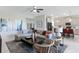 Open-concept living room with modern furniture, connecting seamlessly to the kitchen and dining area at 4779 Waltham Forest Dr, Davenport, FL 33837