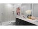 Modern bathroom with a walk-in shower, dual sink vanity, and contemporary fixtures at 466 Puma Loop, Groveland, FL 34736