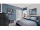 Stylish bedroom with a blue accent wall, comfortable bed, and artwork at 466 Puma Loop, Groveland, FL 34736