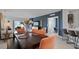 Open dining area with modern furnishings, wood table, and sliding door to backyard patio at 466 Puma Loop, Groveland, FL 34736