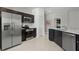 Modern kitchen with stainless steel appliances, dark wood cabinetry, and bright countertops at 466 Puma Loop, Groveland, FL 34736