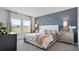 Beautifully styled main bedroom with an accent wall, natural light, and ample space at 466 Puma Loop, Groveland, FL 34736