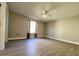 Spacious bedroom with a ceiling fan, laminate flooring and a window with brown curtains at 620 San Pedro Dr, Lady Lake, FL 32159