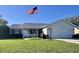 Charming single-story home featuring a well-manicured lawn and a prominent American flag at 620 San Pedro Dr, Lady Lake, FL 32159