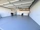 Spacious garage with ample room for parking and storage with utility sink, storage racks and epoxy-coated floor at 620 San Pedro Dr, Lady Lake, FL 32159