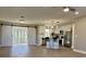Open-concept kitchen with stainless steel appliances, an island with seating, and stylish barn doors at 620 San Pedro Dr, Lady Lake, FL 32159
