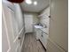 Bright laundry room features a modern washer and dryer set with a granite countertop and ample shelving at 620 San Pedro Dr, Lady Lake, FL 32159