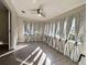 Sun Room featuring many windows with curtains, ceiling fan and wood laminate floors at 620 San Pedro Dr, Lady Lake, FL 32159