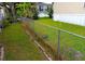 The backyard is fully fenced with grass and some greenery at 109 Fern Dr, Debary, FL 32713