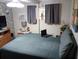 Bedroom with two windows, a TV and A/C unit, and hardwood flooring at 109 Fern Dr, Debary, FL 32713