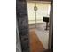 View from the doorway showing a carpeted patio with blinds and an outdoor grill at 109 Fern Dr, Debary, FL 32713