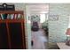 View through brick accent wall, showing armchair, table, and beach picture at 109 Fern Dr, Debary, FL 32713
