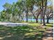 Community volleyball court with lush trees, a grassy area, and a view of the water at 109 Fern Dr, Debary, FL 32713
