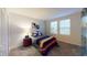 Modern bedroom with neutral colors, a comfortable bed, and two windows with blinds for natural light at 3225 Armstrong Ave, Clermont, FL 34714