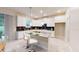 Modern kitchen featuring white cabinets, stainless steel appliances, a center island with seating, and sliding glass doors at 3225 Armstrong Ave, Clermont, FL 34714