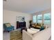 Comfortable living room with neutral tones, plush seating, a decorative rug, and bright natural light at 3225 Armstrong Ave, Clermont, FL 34714