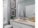 Well-lit bathroom features a vanity with a neutral countertop and a combined shower and tub at 3235 Armstrong Ave, Clermont, FL 34714