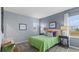 Bedroom showcasing grey walls, carpet flooring, and bright natural light through the window at 3235 Armstrong Ave, Clermont, FL 34714
