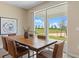 A dining room featuring a wooden table and chairs with an open view of green landscape at 3235 Armstrong Ave, Clermont, FL 34714