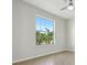 Neutral bedroom with a ceiling fan and large window providing ample natural light at 1762 Regal River Cir, Ocoee, FL 34761