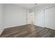 Bright bedroom featuring hard surface floors, white trim, a closet, and ample natural light at 1762 Regal River Cir, Ocoee, FL 34761