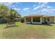 Manicured backyard featuring a swing set and covered patio area at 4530 Old Road 37, Lakeland, FL 33813