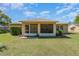 Backyard view of home with screened in patio and mature landscaping at 4530 Old Road 37, Lakeland, FL 33813