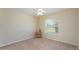 Bright bedroom featuring a large window, neutral carpet, and a ceiling fan at 4530 Old Road 37, Lakeland, FL 33813