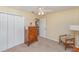 Neutral carpeted bedroom featuring a ceiling fan, chair, and closet at 4530 Old Road 37, Lakeland, FL 33813