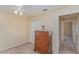 This carpeted bedroom features a ceiling fan and a traditional wood dresser at 4530 Old Road 37, Lakeland, FL 33813