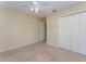 Bedroom featuring a ceiling fan, neutral paint, plush carpeting, and a double-door closet at 4530 Old Road 37, Lakeland, FL 33813