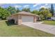 Side view of a one-story home with a two-car garage, long driveway, and a tidy, green lawn at 4530 Old Road 37, Lakeland, FL 33813